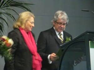 EUHA President Martin Blecker presents the EUHA Golden Badge of Honor—the organization's highest honor—to Inge Steinl, former the managing director of FGH and VHI (today BVHI).