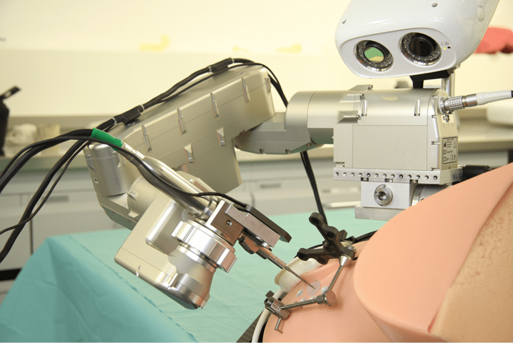 Robot aligned with entry trajectory on phantom head. © ARTORG Center for Biomedical Engineering Research, University of Bern.