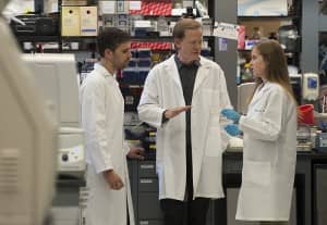 Albert Edge, PhD (center), hearing researcher at Mass. Eye and Ear, meets with research fellows working in his lab aimed at restoring hearing through regenerating sensory cells in the ear. Credit: John Earle.