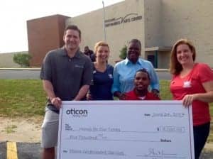 Oticon's David Horowitz presented a $5000 check to Homes for Our Troops representatives and veteran Timothy Birckhear and his mother, Gloria.