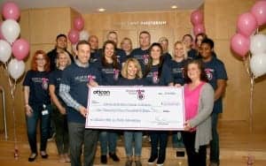Oticon President Gary Rosenblum celebrates success of the Oticon “Hear in Pink” Campaign with the presentation of a check for $10,000 to National Breast Cancer Coalition Board Member Joy Simha.