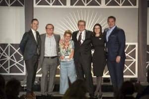 L to R: Mason Walker, President; Brandon Dawson, CEO; award winner and member Kate Tuomala; Mike Halloran, CFO; Misty Stern, EVP Operations and Marketing; and Connon Samuel, COO Audigy Medical.