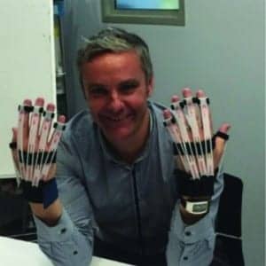 Figures 1a-b. Left: Author with the Cambridge Simulation Gloves. Right: 5-point Likert Scale for rating ease of use.