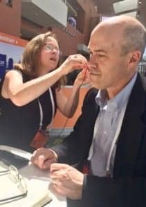 MED-EL’s Acoustic Systems Manager Amanda O’Donnell demonstrates the ADHEAR system to HR Editor Karl Strom at the 2018 American Academy of Audiology Convention in Nashville.