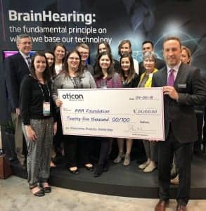 Oticon President Gary Rosenblum presented a $25,000 donation to the American Academy of Audiology Foundation’s (AAAF) Empowering Students scholarship fund to Georgine Ray, AuD, Secretary/Treasurer of the American Academy of Audiology Board of Trustees.