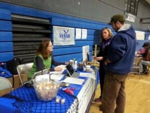 Alaska Sea Grant Marine Advisory agent Torie Baker speaks with fishermen in Cordova, Alaska, in 2015 about participating in a study about fishermen’s health led by a University of Washington researcher Debra Cherry, MD.
