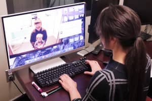 Claire Monroy observes a deaf infant in a study at The Ohio State University Wexner Medical Center testing babies’ visual processing skills. They found that deaf infants took longer to encode visual stimuli than hearing infants.