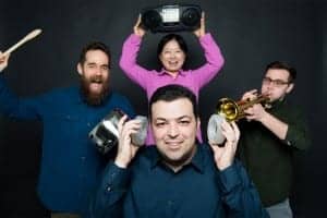 Boston University mechanical engineers have created synthetic, sound-silencing structures—acoustic metamaterials—that can block 94% of sounds. Reza Ghaffarivardavagh (ENG) (front center) holds two of the open, ringlike structures over his ears while Stephan Anderson (MED) (left), Xin Zhang (ENG) (rear center), and Jacob Nikolajczyk (ENG) (right) make a racket. Photo by Cydney Scott