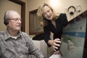 Nancy Tye-Murray, PhD, right, has developed training software to let patients with hearing loss practice listening to the voices they most want to hear. Tye-Murray helps Lonnie Willmann record audio clips for his wife, Kathleen Willmann, who has been diagnosed with hearing loss. Photo Credit: Robert Boston