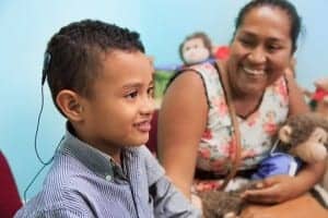 Alejandro after the successful activation of his cochlear implant: for the first time, he can hear his mother's voice.