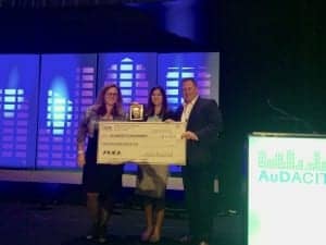Jasmine Wilson (center) of the University of North Carolina is presented with a $5000 check and first place in the Student Business Plan Competition by Dr Morris and the competition's host Shawn Parker of Fuel Medical Group.