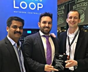 Per Persson, director of international sales for Williams Sound (right), presents the 2017 International Distributor of the Year award to Shajahan Kunnath (left) and Dino Drimakis from NMK.