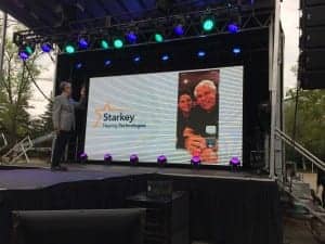 Bill and Tani Austin, who were on a Starkey Hearing Aid Foundation mission in Madagascar, joined the event via Skype to thank employees for their dedication and hard work in developing Livio AI.