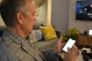 David Fabry checks the fitness app which draws its data from the embedded motion sensors in the Livio AI hearing aid he is wearing.