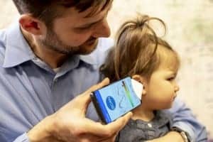 Dr. Randall Bly, an assistant professor of otolaryngology-head and neck surgery at the UW School of Medicine who practices at Seattle Children’s Hospital, uses the app to check his daughter’s ear.Dennis Wise/University of Washington
