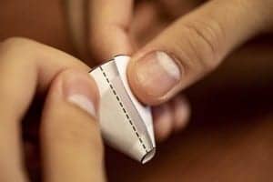 The system uses a regular piece of paper cut and folded into a funnel to guide sound waves in and out of the ear canal. Photo credit: Dennis Wise/University of Washington