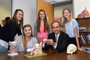 Ali Danesh, Ph.D., (seated on the right) co-author, a professor of communication science and disorders in FAU’s College of Education, a professor of clinical biomedical sciences in FAU’s Schmidt College of Medicine, and a member of FAU’s Brain Institute (I-BRAIN), and his students (from left) Amanda (Mandy) Suhandron, Allison Forrester, Amanda Marks, and Stephanie Howery (Photo credit: Teresa Crane).